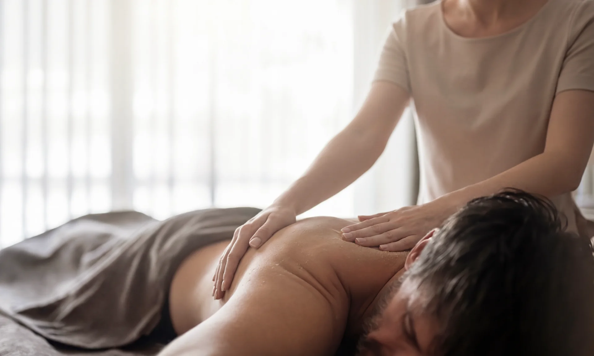 Man receiving professional back massage in a calm setting