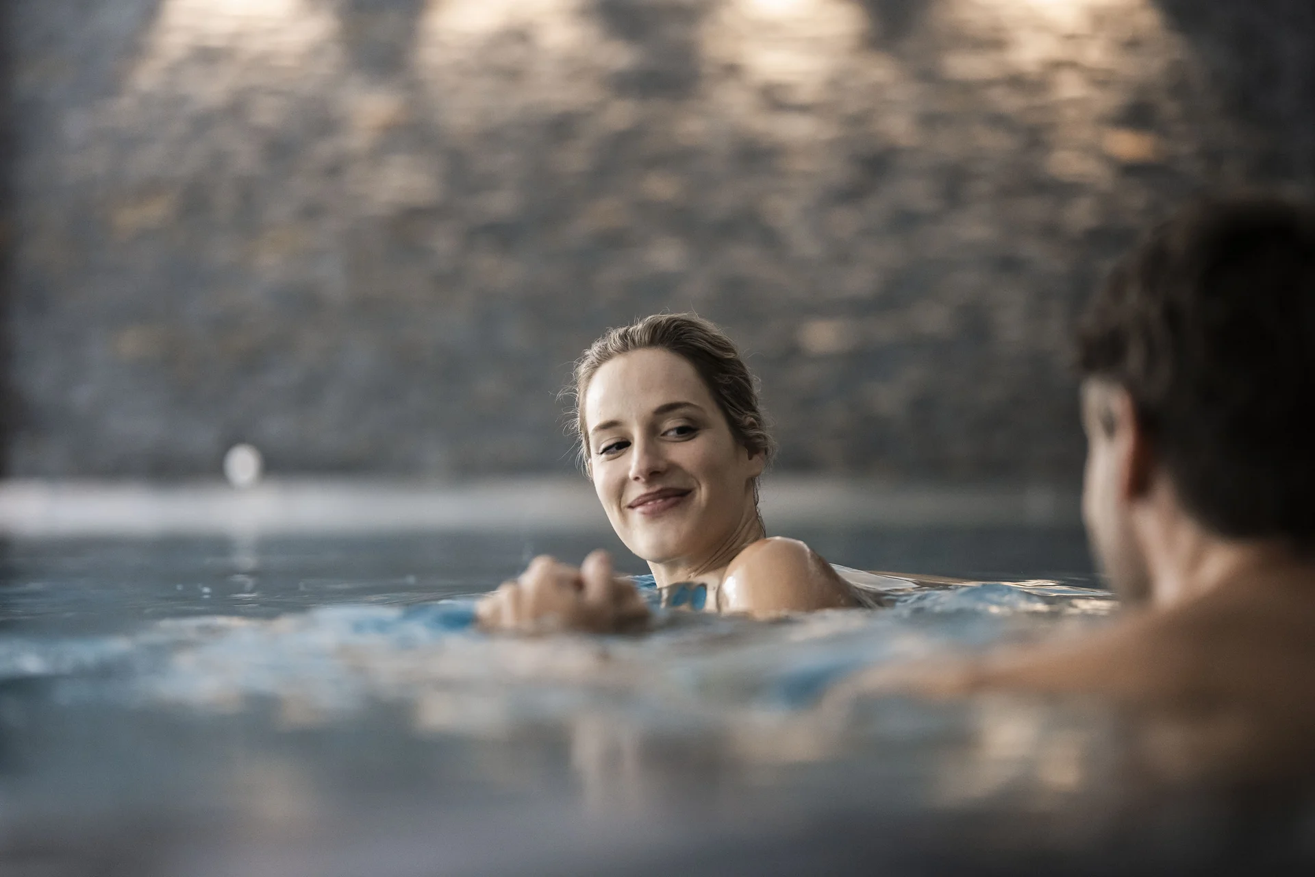 Woman and man enjoying time together in a pool