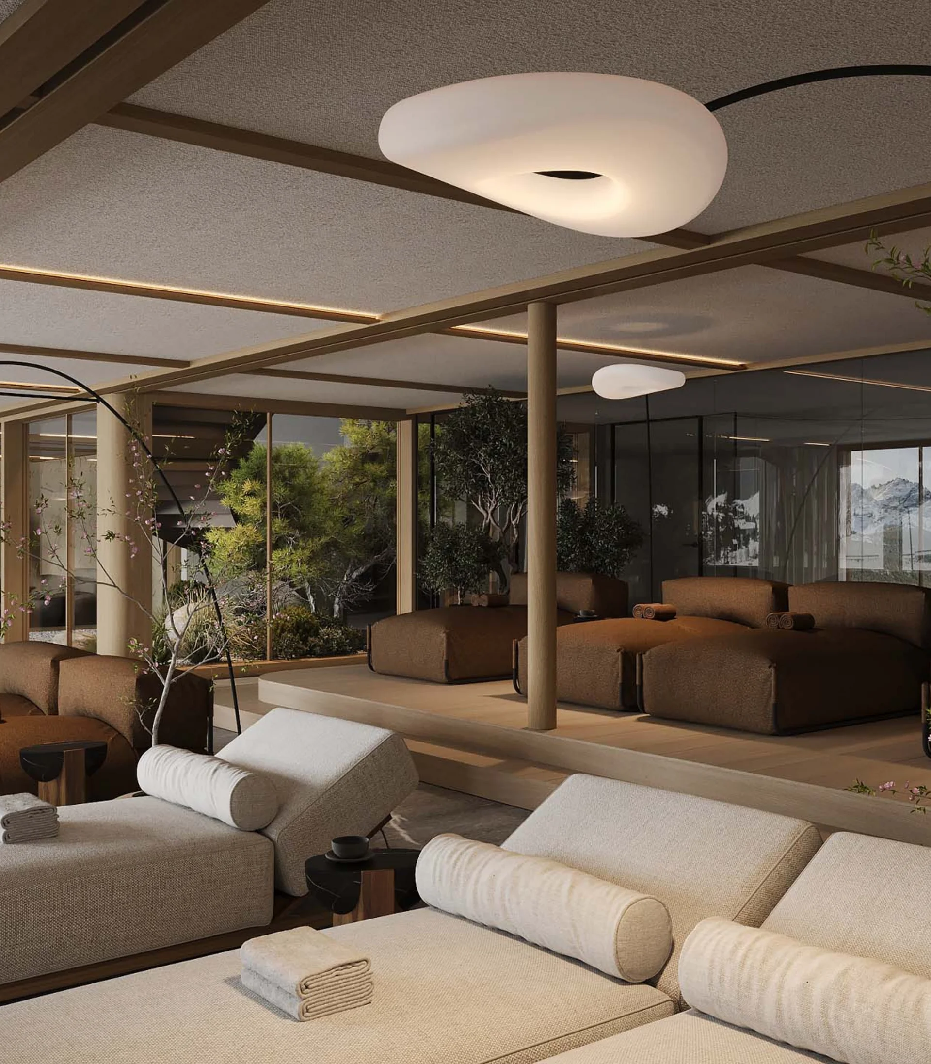 Modern relaxation room with loungers and large windows showing mountain views