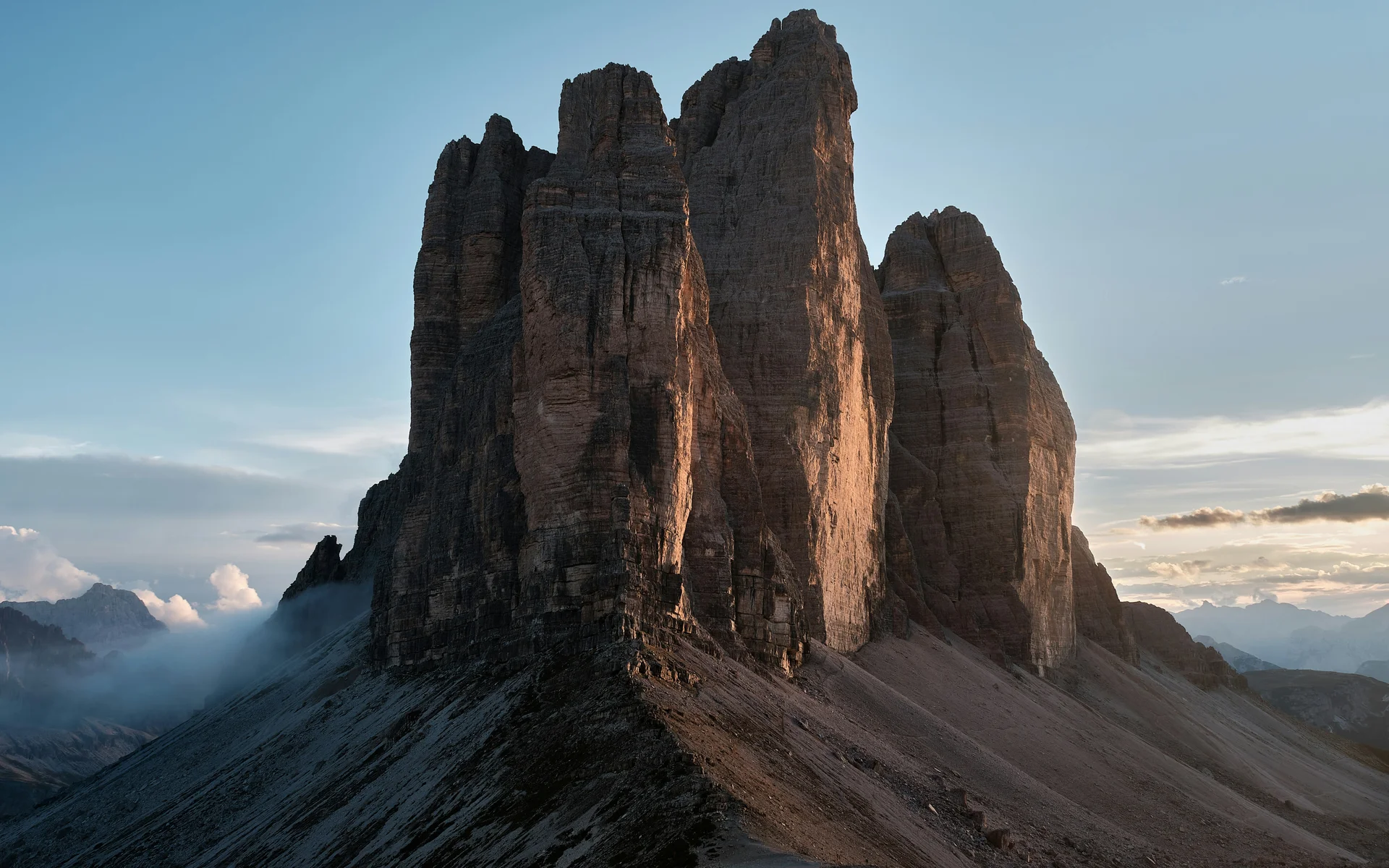 Rock formation in the Dolomites at sunset with cloudy sky