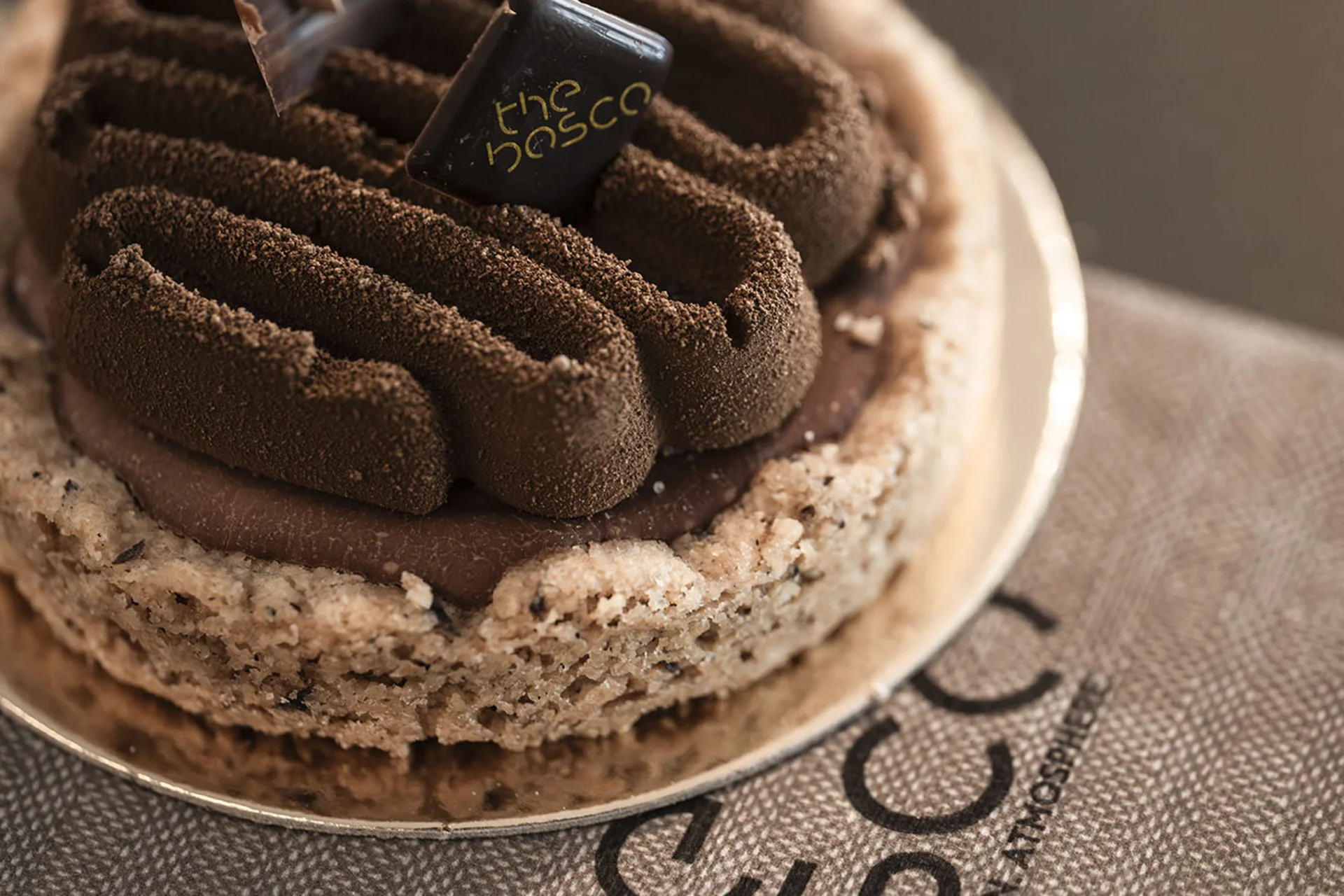 Chocolate cake with cookie base on a plate on a cloth