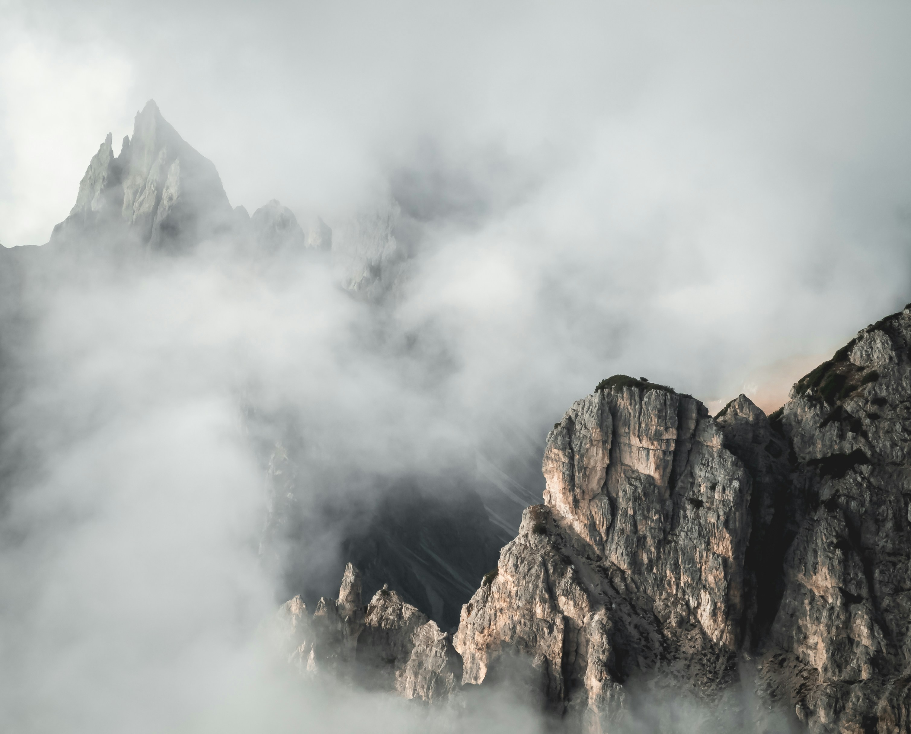 Rocky mountain peaks surrounded by thick fog
