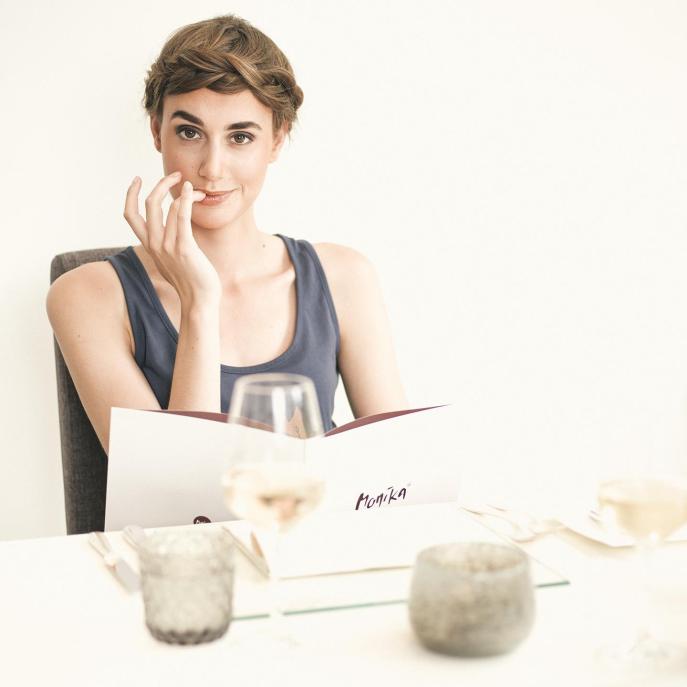A woman is reading the menu