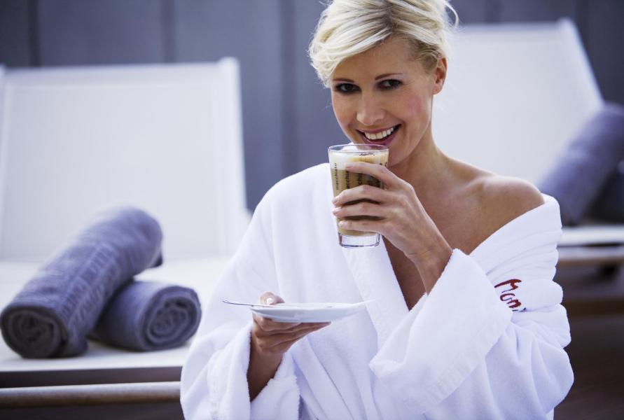 A woman is drinking latte macchiato