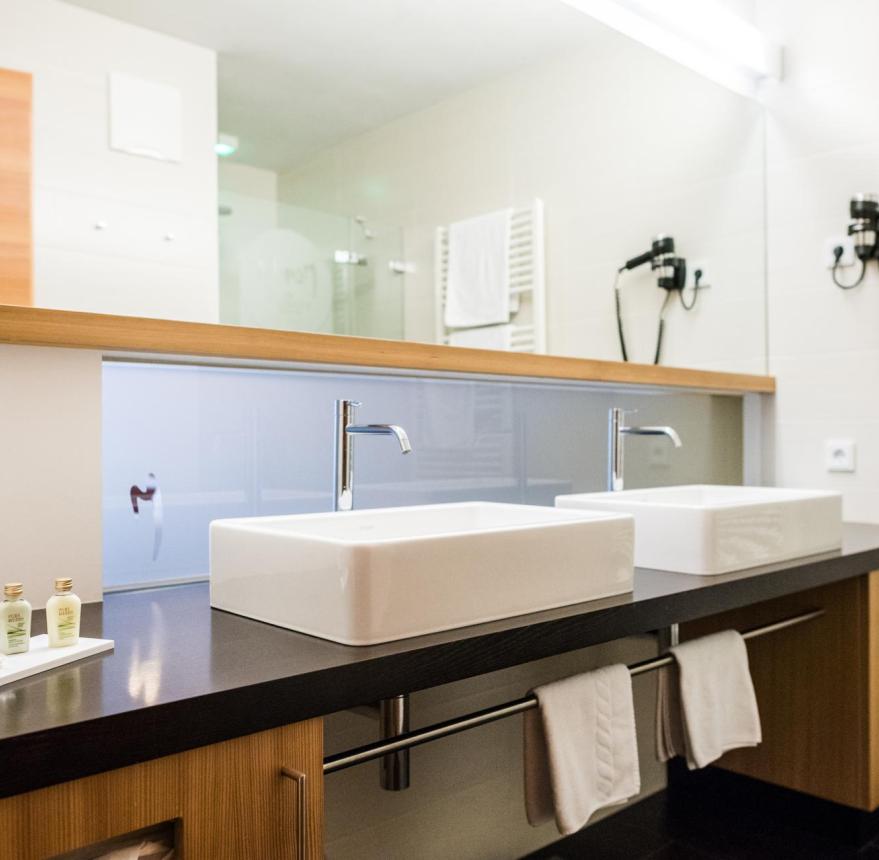 Bathroom with a shower and two sinks